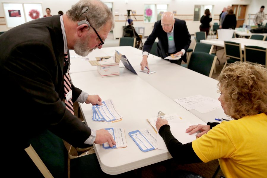 Iowa Caucus precinct workers count and tally Iowa Democratic Caucus votes by hand as caucus votes are counted after a Democratic presidential caucus at West Des Moines Christian Church in West Des Moines, Iowa, U.S., February 3, 2020. Picture taken February 3, 2020. REUTERS/Jim Bourg