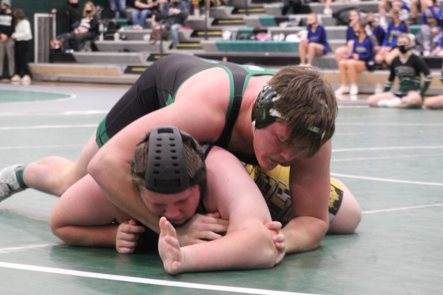 Senior Kody Huisman putting his opponent in a crossface while hes flat on the mat. 