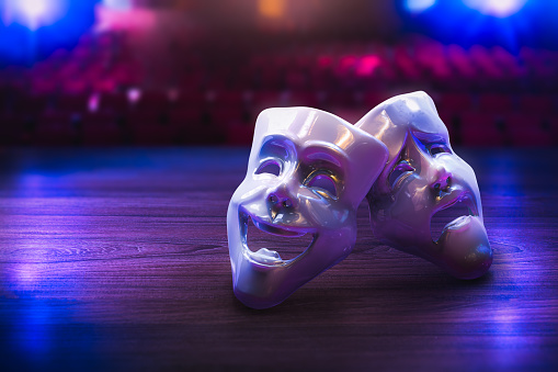 Theater masks, drama and comedy on a dark background / 3D Rendering