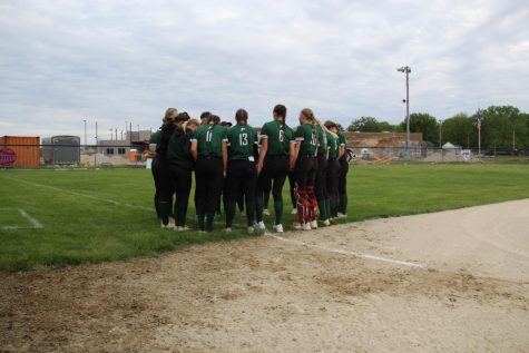 The PHS Varsity softball team does a team prayer before the game. 