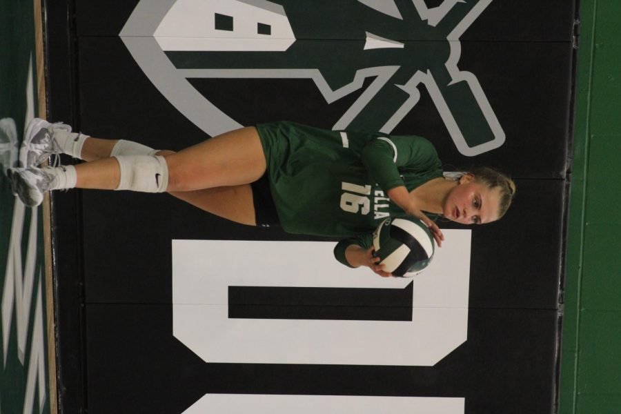 Katie Scheckel gets ready and focus’ on serving the ball. 