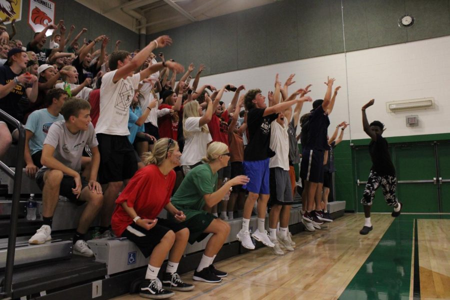 Student section does the wave during a timeout during the volleyball game. 