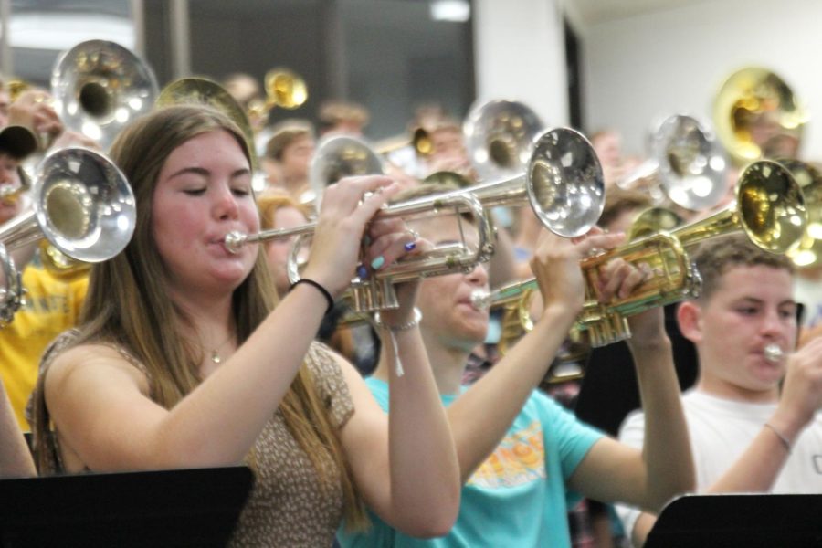 Sophomore Sydney Namminga plays the school fight song with the Marching Dutch. The marching band played the fight song, as well as snippets from their field show during the assembly. “I’m proud to be a member of the band and hype everyone up,” said Namminga.


