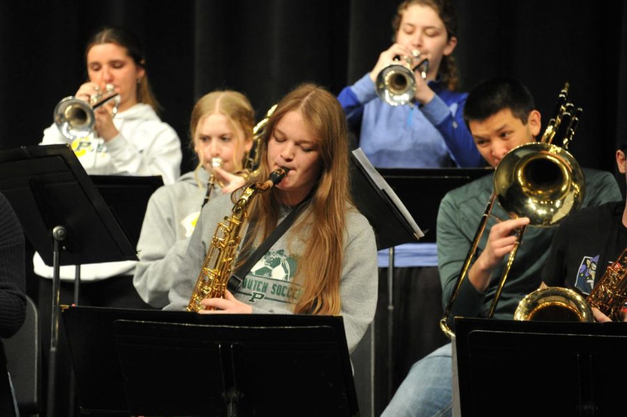 Junior Emmalee Spurgeon focuses on the music sheet while playing the saxophone. 