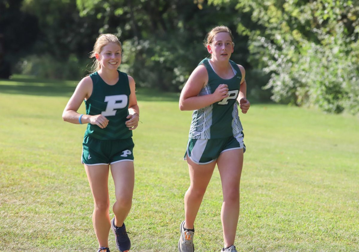 Morgan McAninch and Cameron Knouse run together at the Central course last Saturday.