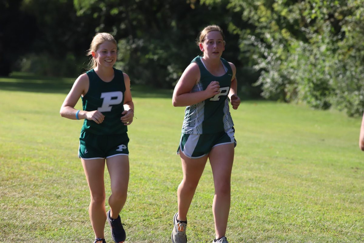 Morgan McAninch and Cameron Knouse run at the Central course.