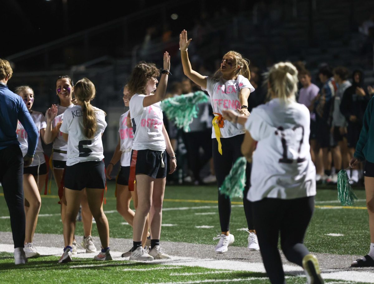 Seniors Lacy Bainum and Lexie Bryan give each other high fives.