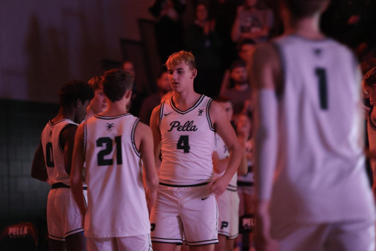 Senior Tyson Barnes does his handshake with Senior Aren Hellbusch during lineup introductions. The team beat Gilbert 79-72 in an exciting game. "I feel like this season has been really fun so far," said Barnes. "We've had our ups and downs but it's really fun going through it all with my teammates."