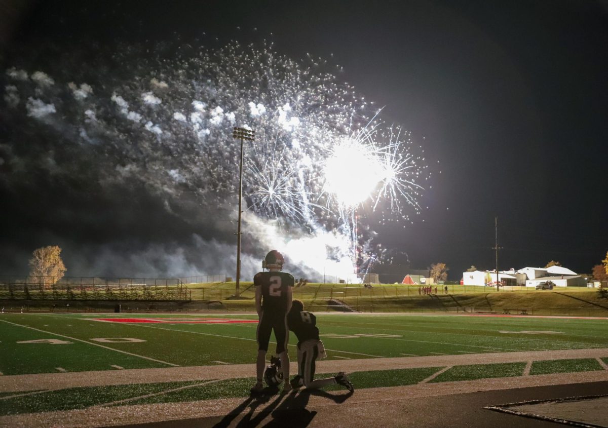 Juniors Harry Mullens and Micheal Manning watch the fireworks. The Pella football team beat Gilbert in the second round of the playoffs to advance to the Dome in Cedar Falls. "I had a great experience with the playoffs. I felt myself and the team give it all we had every game. Every game we improved more and more, and it was a good feeling and it payed off in the dome. Being a part of Championship history made it much more enjoyable," said Mullens.